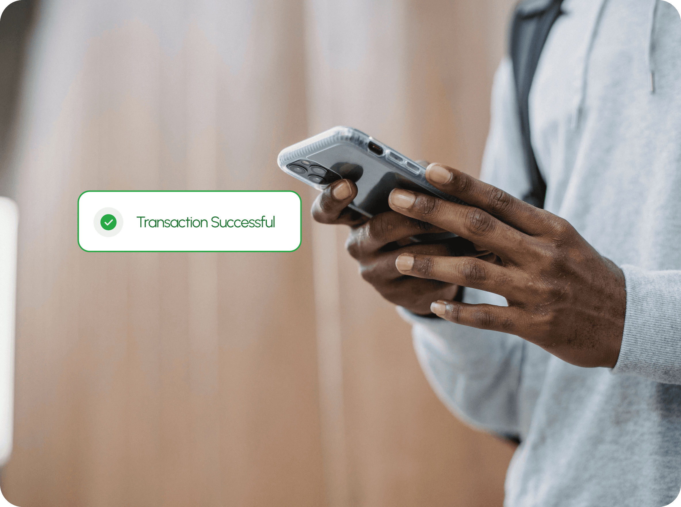 Person confirming a successful transaction on their phone